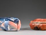 two small figurines sitting next to each other on a table