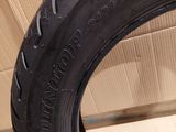 a close up of a tire on a cardboard box with a cardboard box in the background