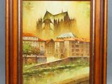 an oil painting of a castle in a wooden frame on a wall