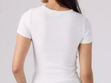 a woman in a white shirt and jeans stands back to back