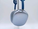 a pair of headphones sitting on top of a white stand
