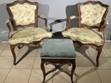 two chairs and a foot stool sitting on a tiled floor