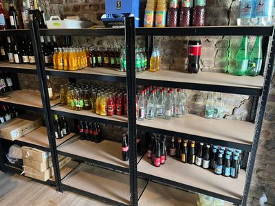 many bottles and cans on the shelves in the store