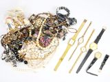 a lot of jewelry on a white surface with a ruler