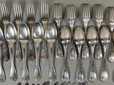 a lot of forks and spoons that are on the table