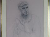 portrait of a man in a cap and shirt with his arms crossed