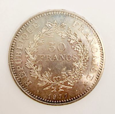 a close up of a coin on a white surface with a white background