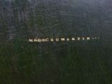 a close up of a black book with a gold writing on it