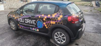 a small car that is parked on the side of the road