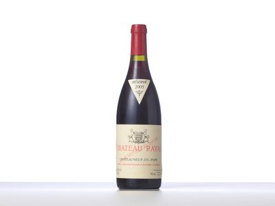 a close up of a bottle of red wine on a table