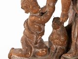 statue of a woman with a child and a dog on a pedestal