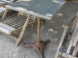 two chairs and a table on the concrete patio