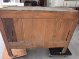 an old wooden chest sitting on wheels in a room