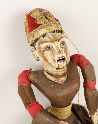 a wooden statue of a man with a hat on