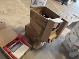 a cardboard cart with a laptop inside of it on the floor