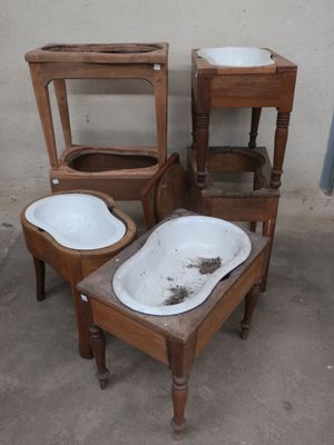 three old wooden chairs and a sink in a room