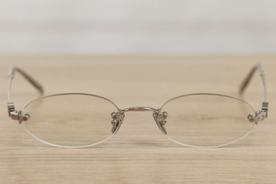 a pair of glasses sitting on a wooden table