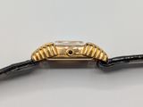 an image of a gold watch with a black strap