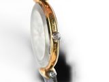 an image of a close up of a watch on a white surface