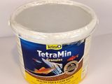 a tub of tetra - min fish food sitting on a table