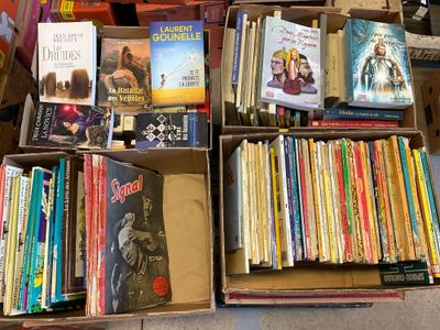 many books that are sitting in a box on the floor