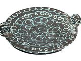 an image of a decorative bowl with a handle