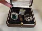 a person holding a ring in a box on a table