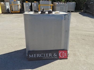 a silver refrigerator sitting in the middle of a parking lot