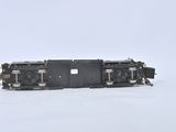 a black train car sitting on the tracks in the snow
