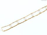 a close up of a gold chain bracelet on a white background