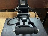 a black machine that is sitting on top of a wooden table