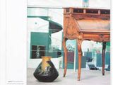 a book with a picture of a desk and a vase on it