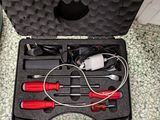 a black case with tools inside of it on the floor