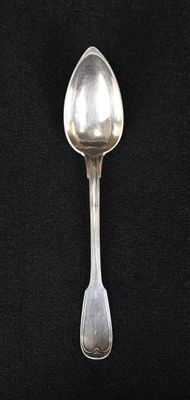 a spoon that is sitting on a black surface