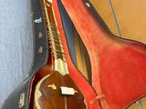 a guitar in a case sitting on the floor