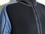 a mannequin wearing a black and blue jacket on a mannequin mannequin