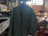 a green jacket hanging on a chair in a room