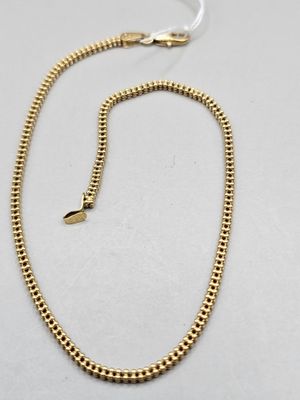 a gold chain with a clasp on a white background