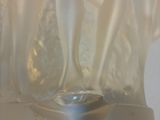 a glass vase with a white flower inside of it