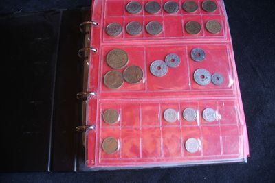 a picture of a red binder with coins in it
