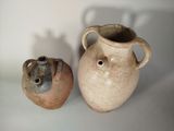 two vases sitting next to each other on a table