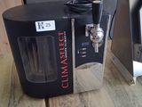 a coffee maker sitting on a wooden table in a kitchen