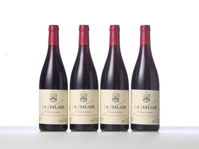 three bottles of red wine sitting on top of a table