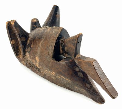 an old wooden mask on a white surface with a white background