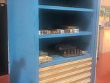 a blue cabinet that has a lot of shelves on it
