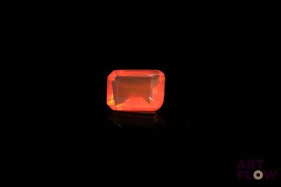 an orange diamond in the dark with a black background