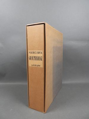 an old book sitting on top of a table next to a gray background