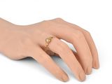 a close up of a person ' s hand with a ring on it