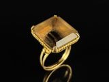 an image of a gold ring with a square cut citrine stone