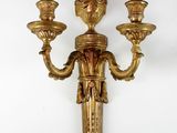 an image of a wall sconce with three candles on it